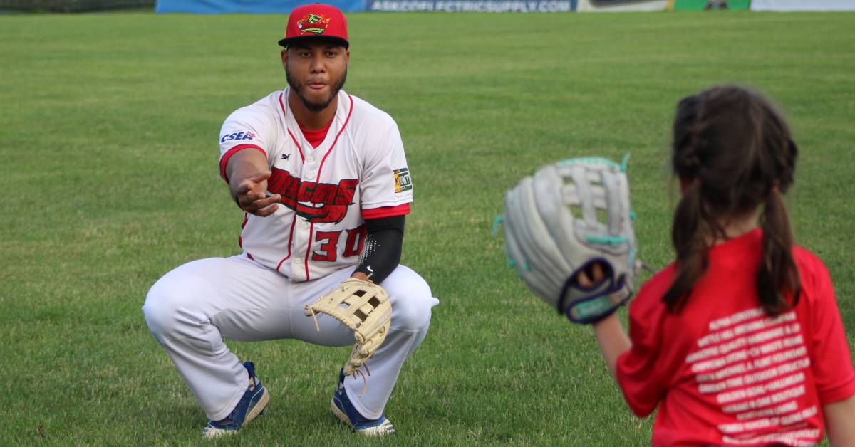 glens falls dragons player plays with little girl