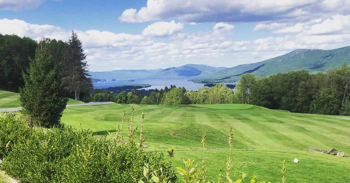 golf course with lake view in distance