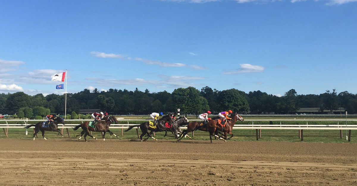 horses racing down a dirt track