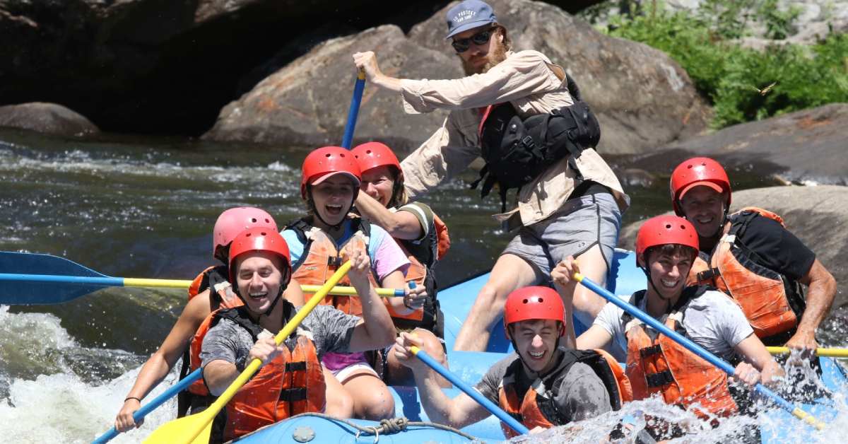 group of rafters in a light blue raft