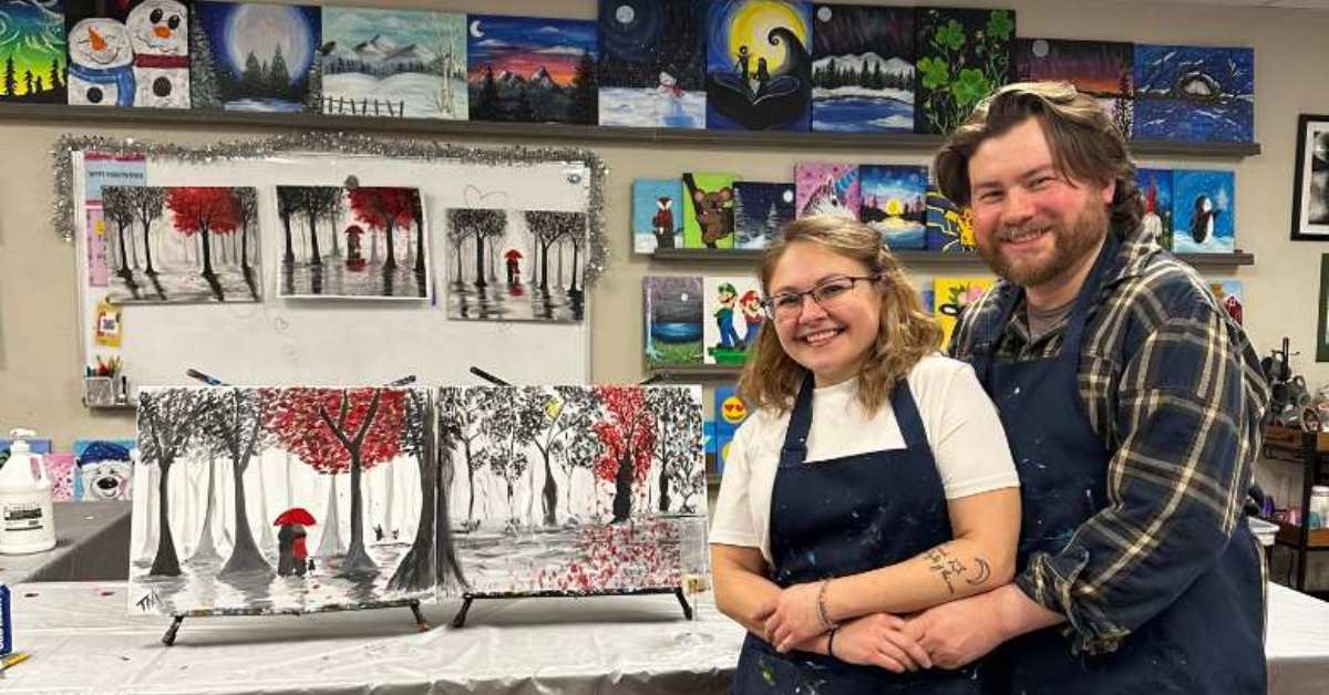 couple smiling with their paint & sip