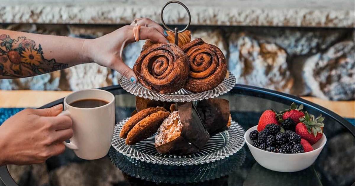 Display of pastries and fruit with a mug of tea