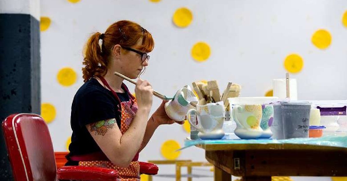woman painting pottery