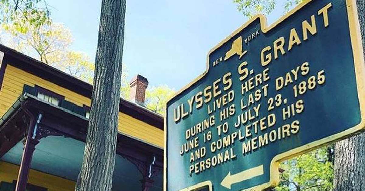 The sign for Grants Cottage in front of the cabin