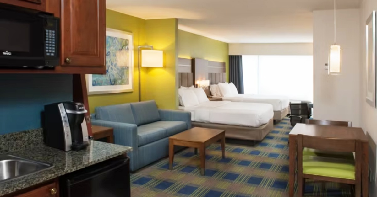 hotel room with a living area and sink area