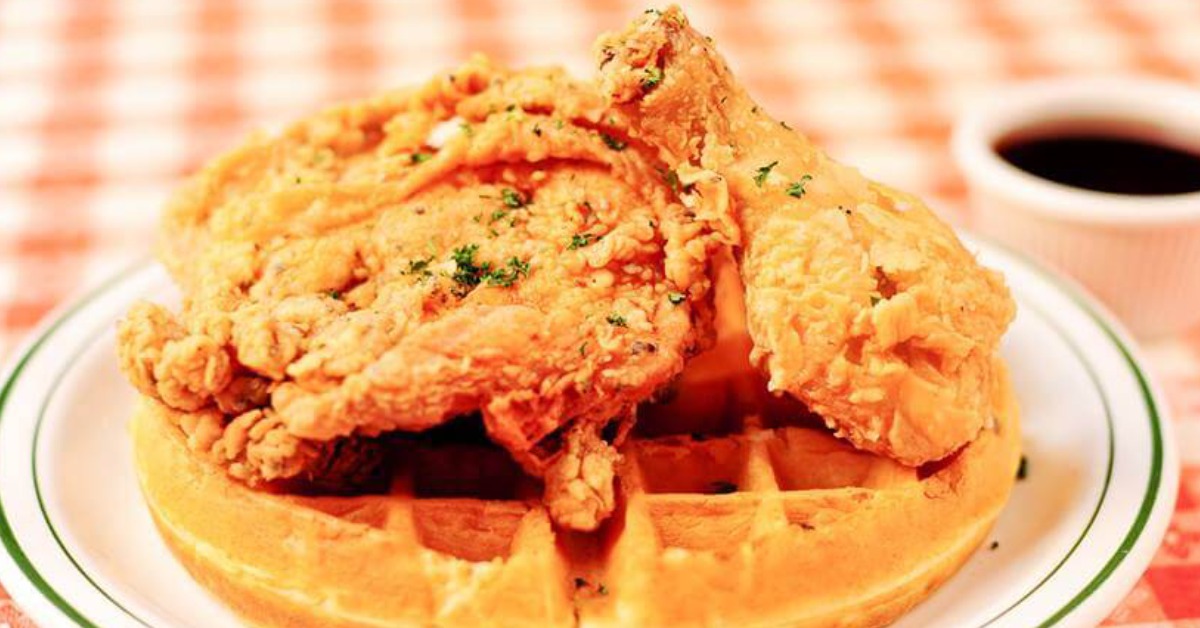 Fried chicken sitting over a waffle