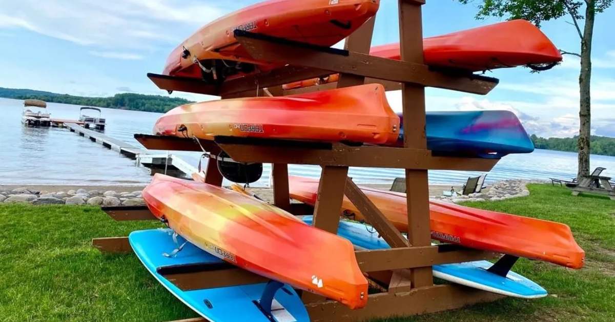 colorful kayaks in a rack by a lake