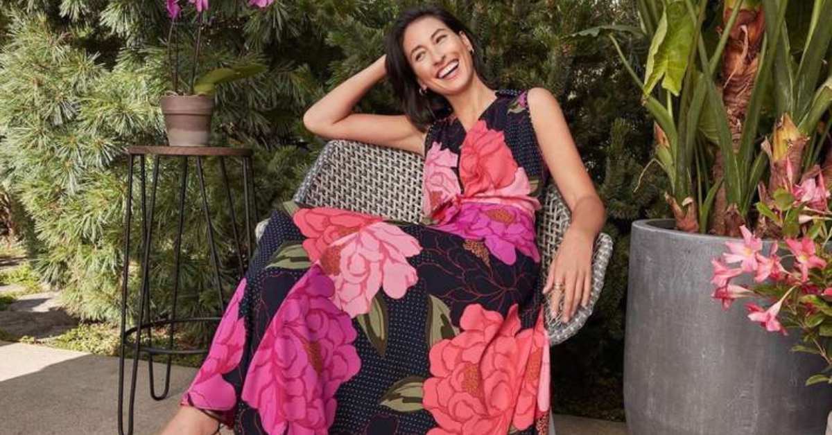 woman in a floral print dress lounging on a chair 