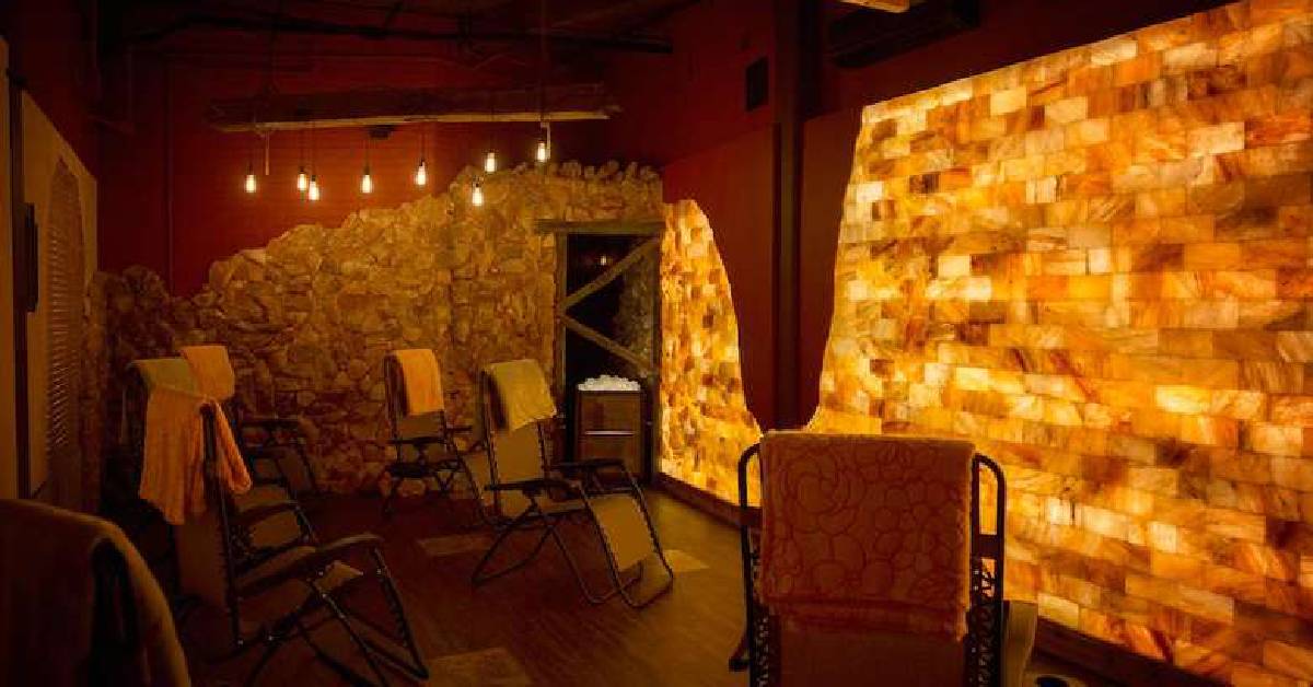 Salt wall with warm light and chairs 