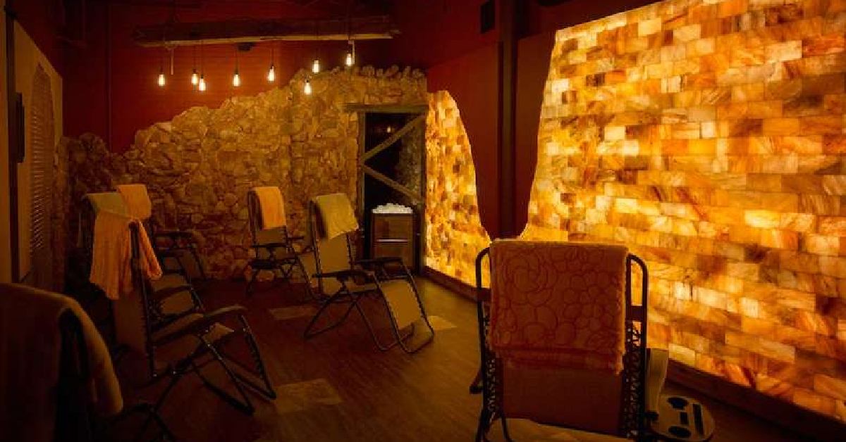 a man-made salt cave with lounge chairs and warm lighting
