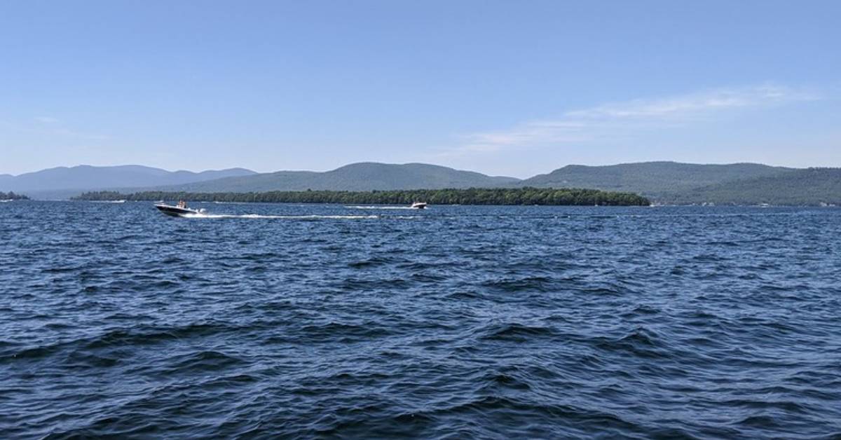 a boat moving left across a lake