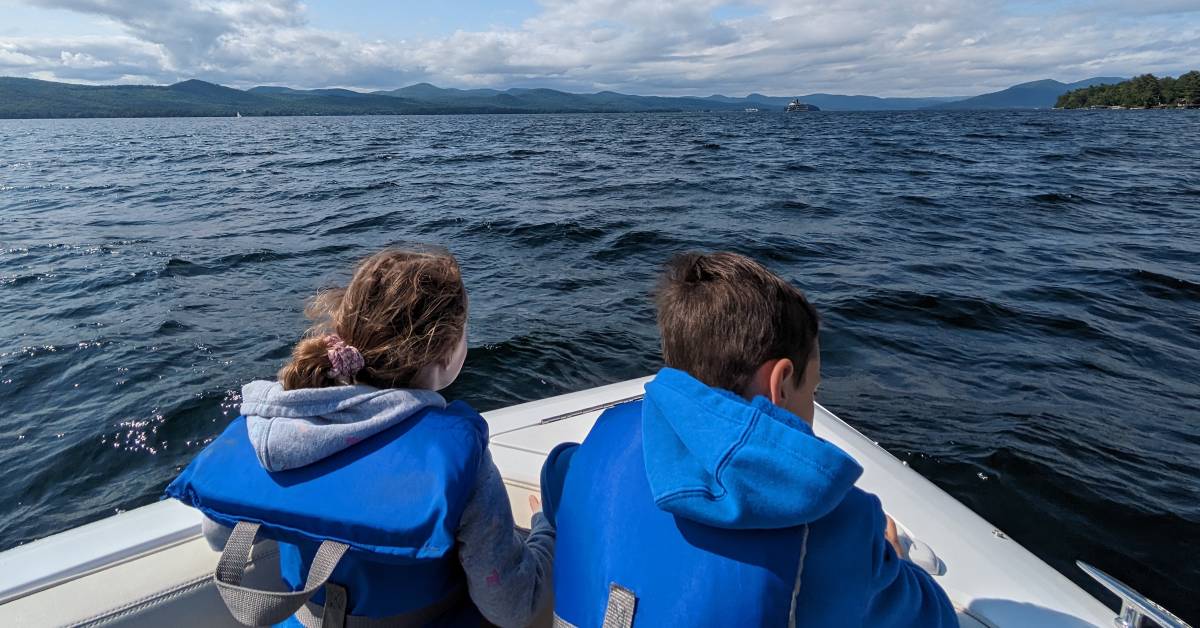 kids in lifejackets on boat on lake george