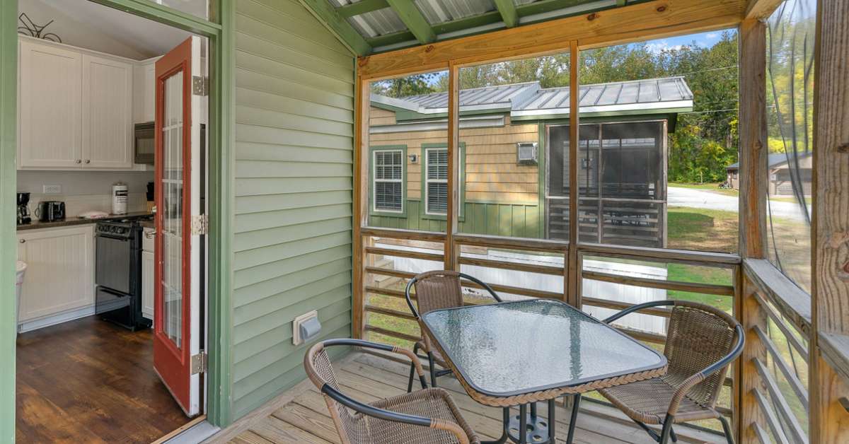 inside a cabin porch with table and chairs