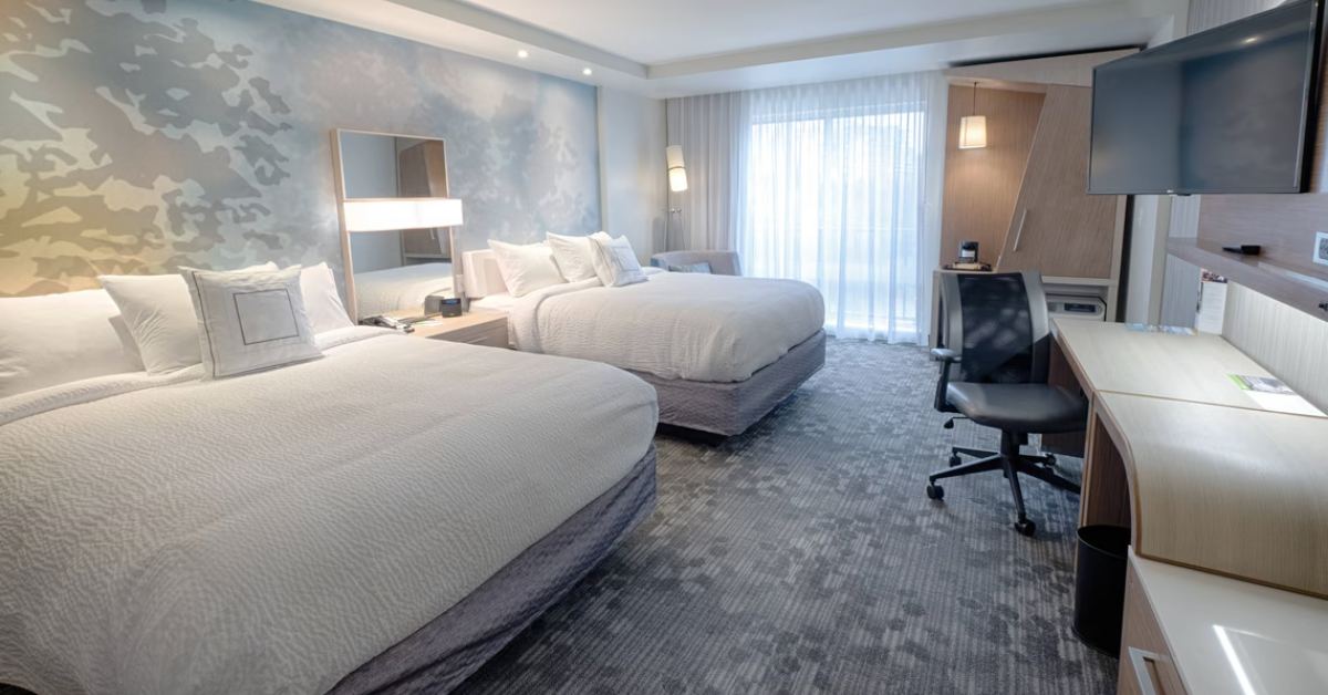 hotel room with two large beds and workspace