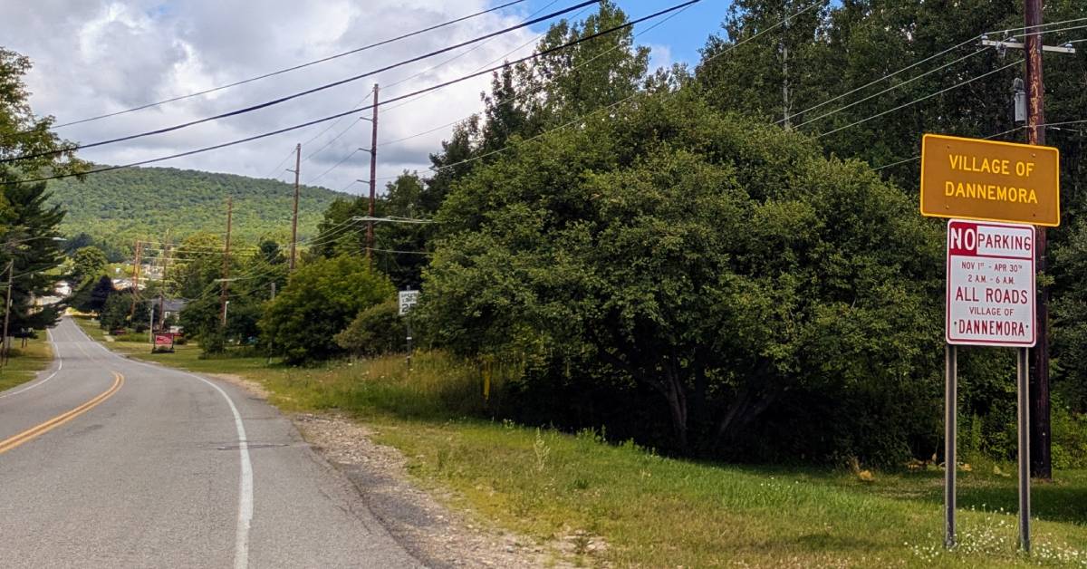 village of dannemora sign next to road