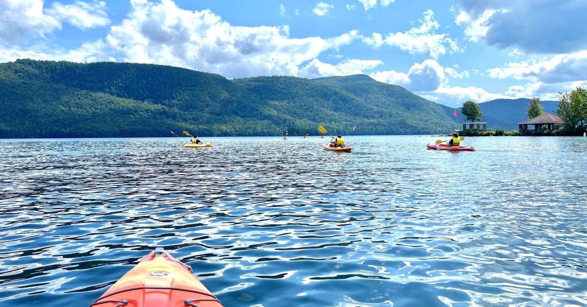 kayakers on a lake with flags