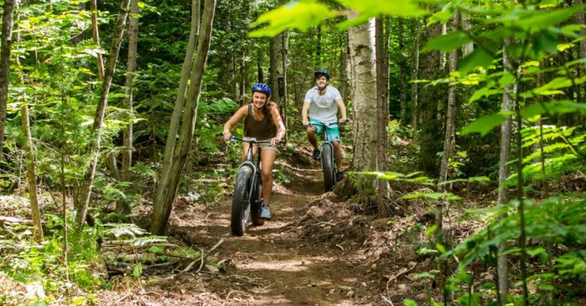 man and woman mountain biking on a trail