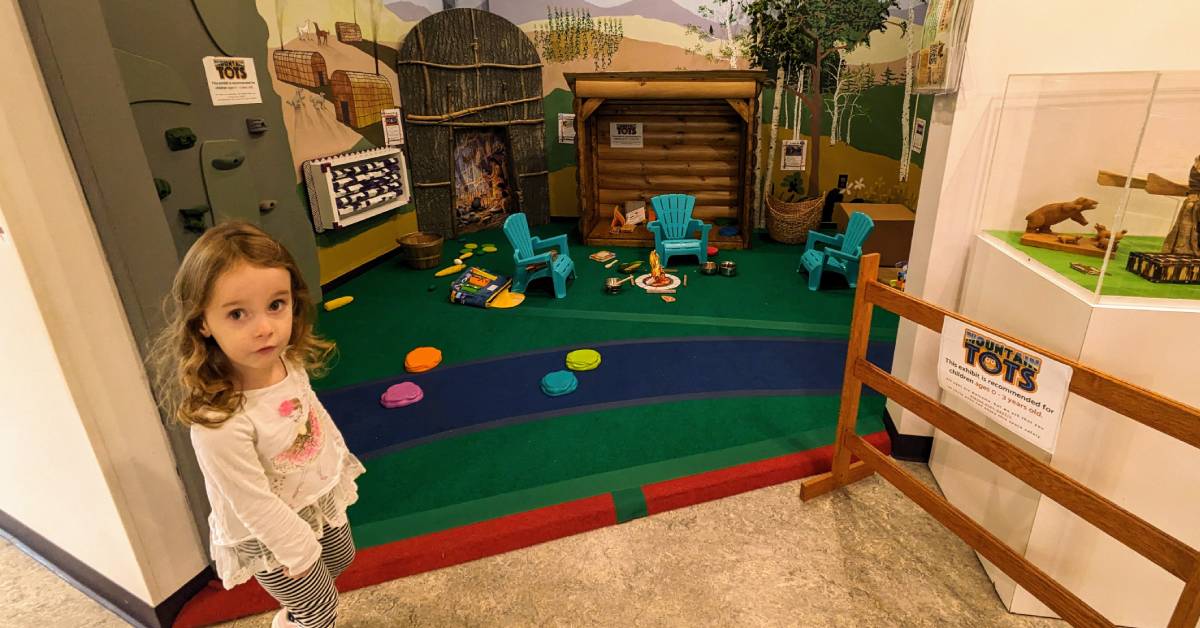 little girl at world awareness children's museum adirondacks exhibition