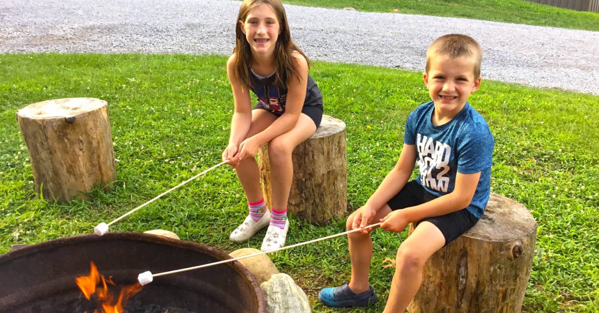 two kids roasting marshmallows