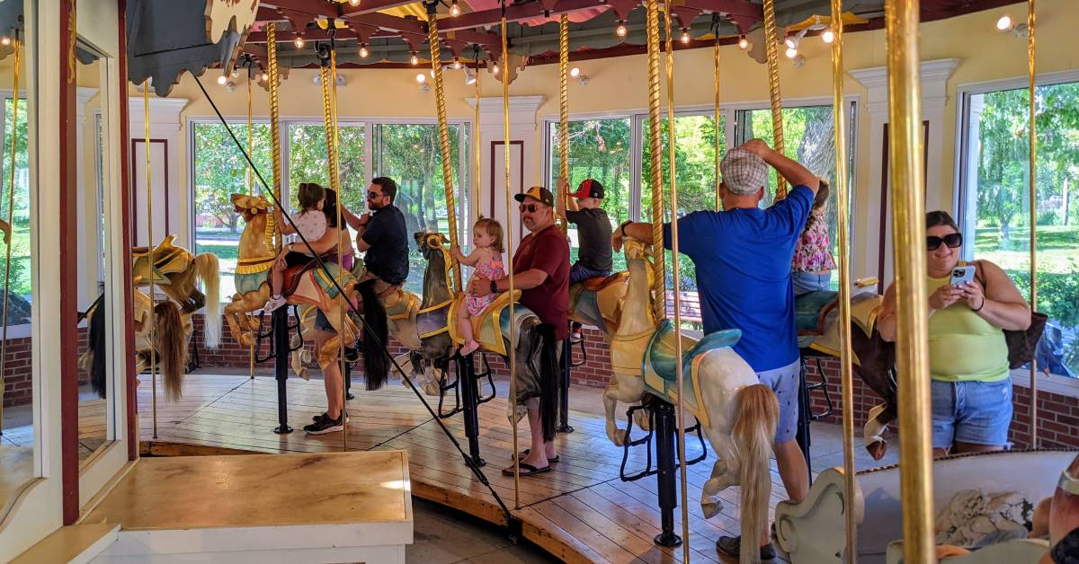 people riding a carousel