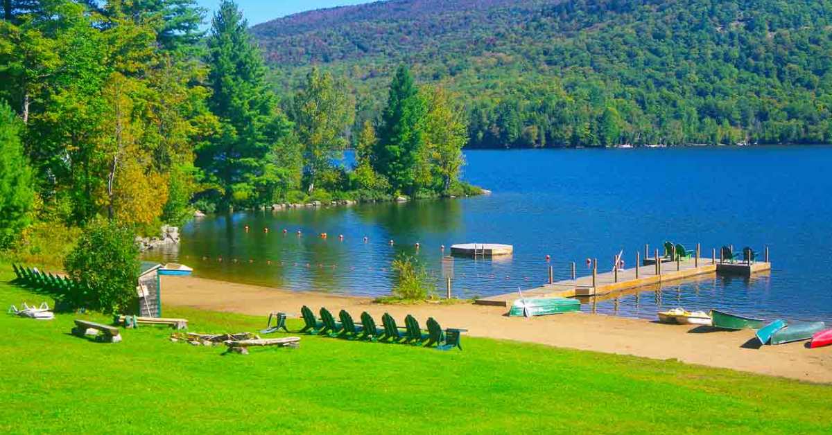 a scenic lake beach with sandy shoreline and dock