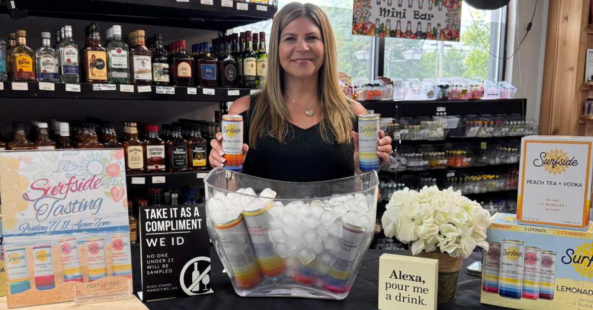 woman holding cans of Surfside drinks