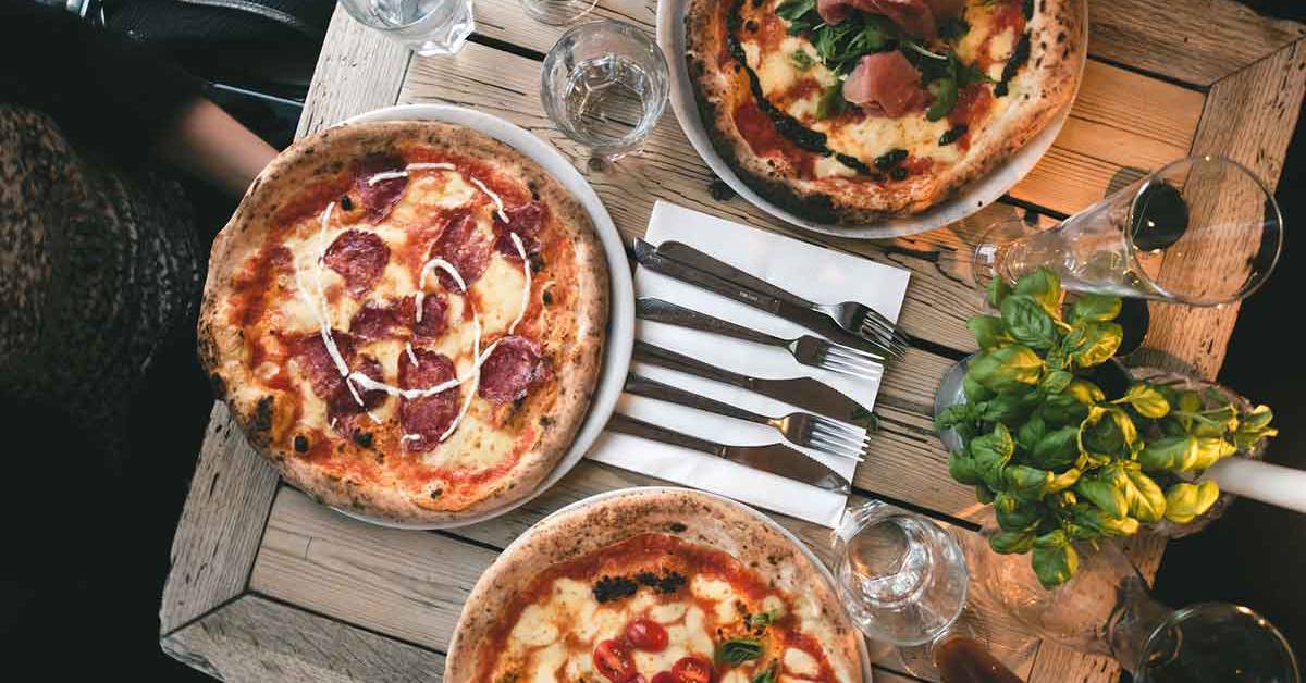 pizzas and basil on table