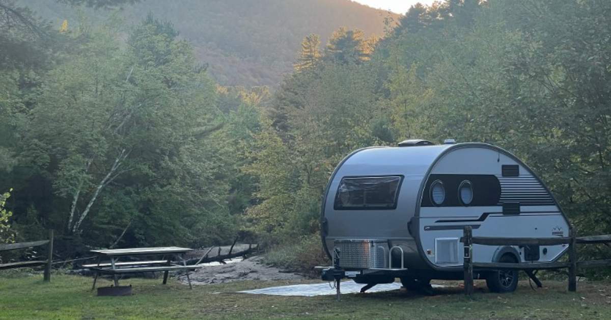 camper on a campsite with view of mountains in the background