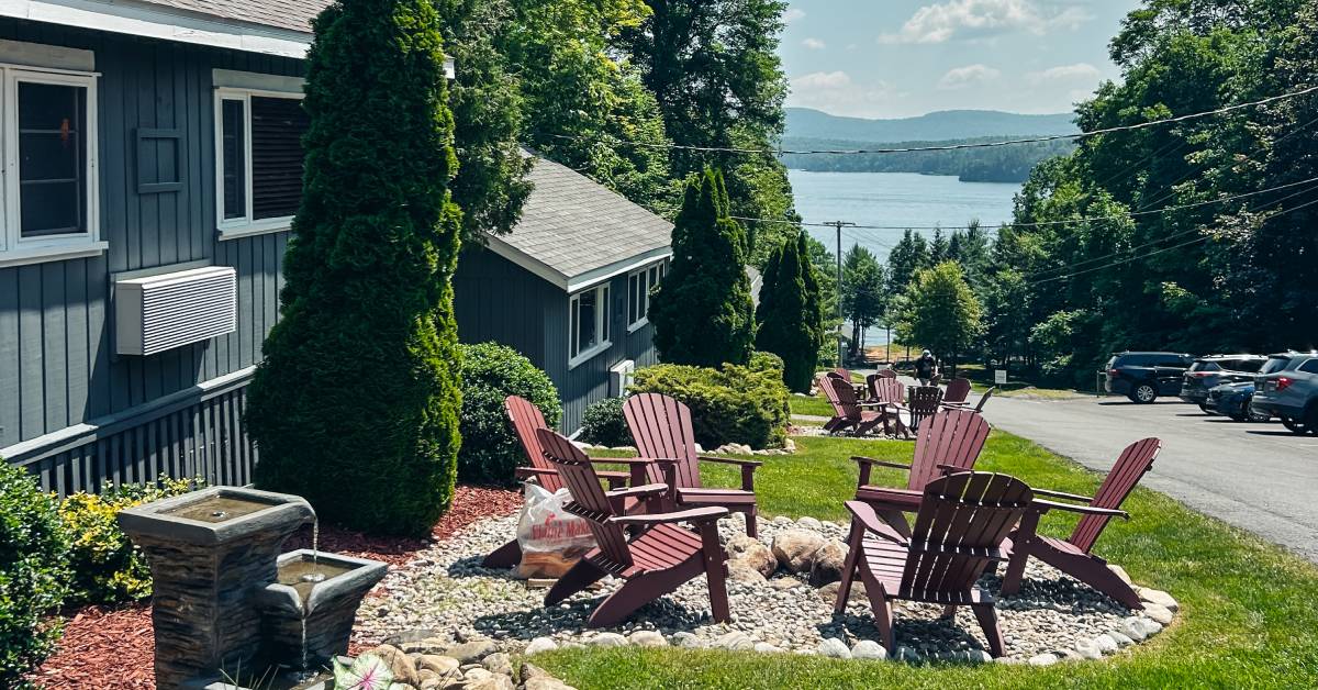 adirondack chairs and fire pit in front of cabin
