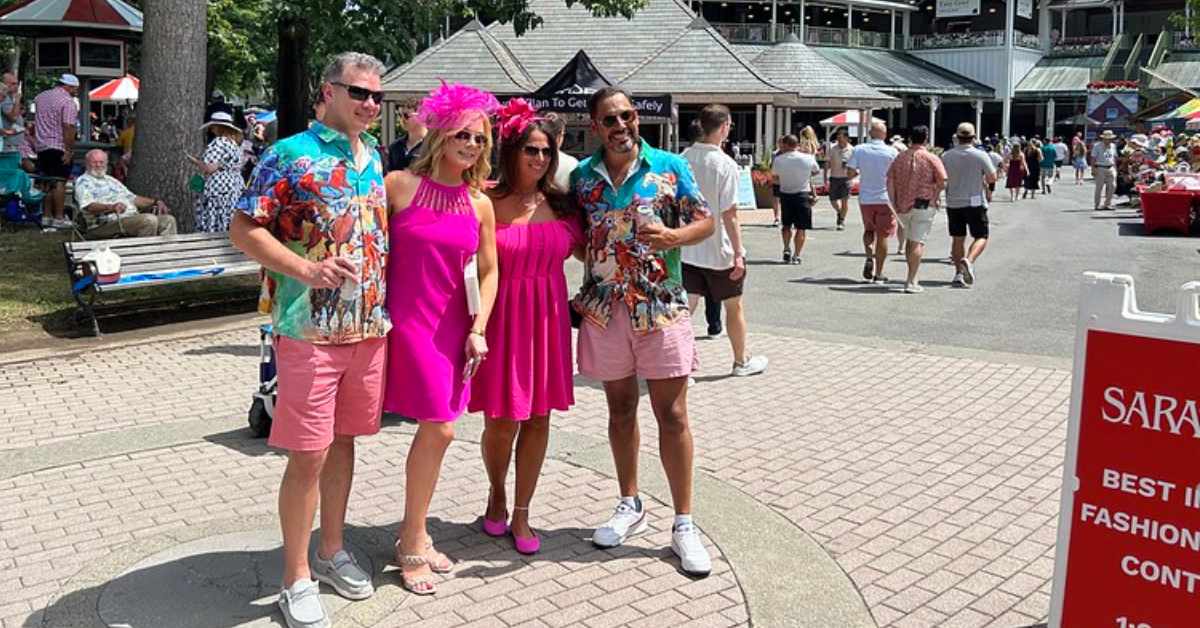 people dressed up in pink for Whitney Day at Saratoga Race Course