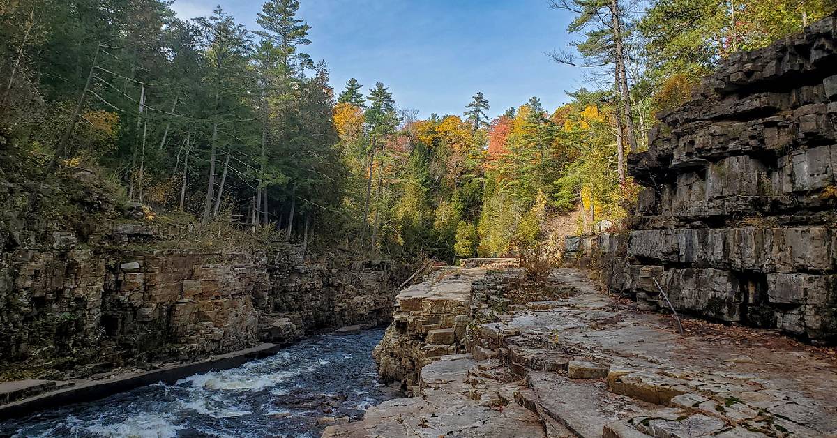 Water rushing with beautiful fall colors with surrounding rocks