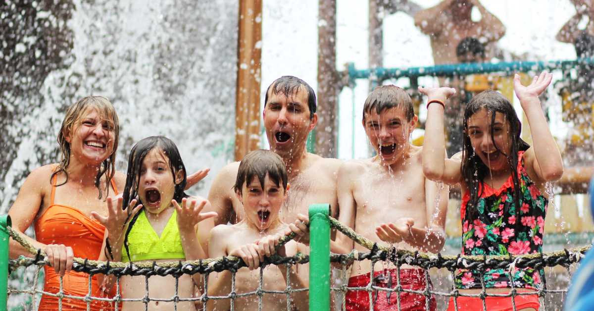 Family with water crashing down on them at amusement park