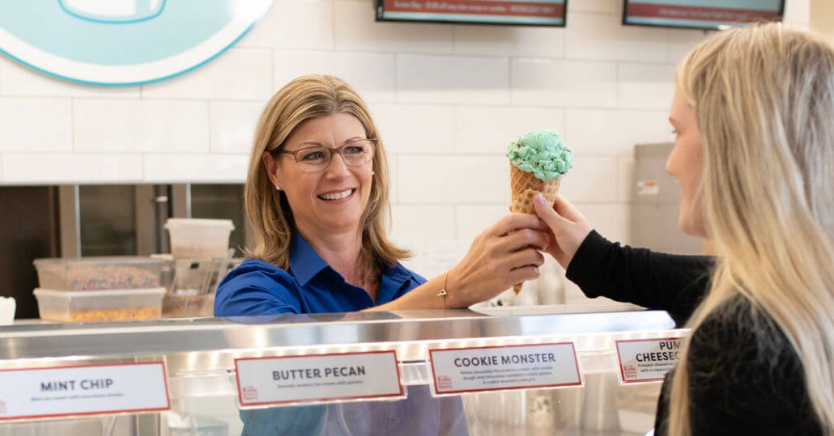 Women handing a customer an ice cream cone