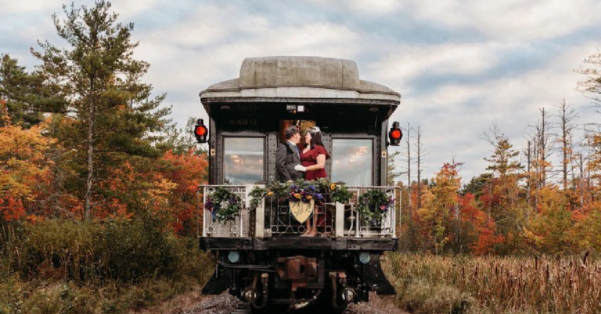 Couple on the back of the train post wedding 