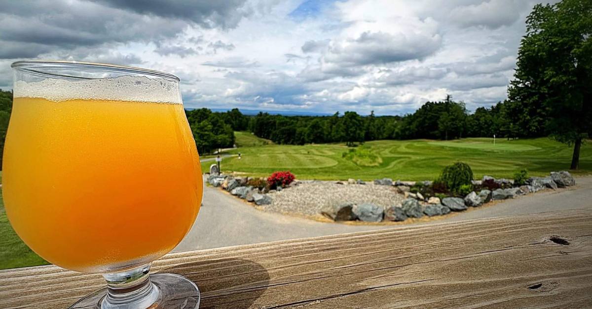 Glass with bear wih a golf course in the bakground