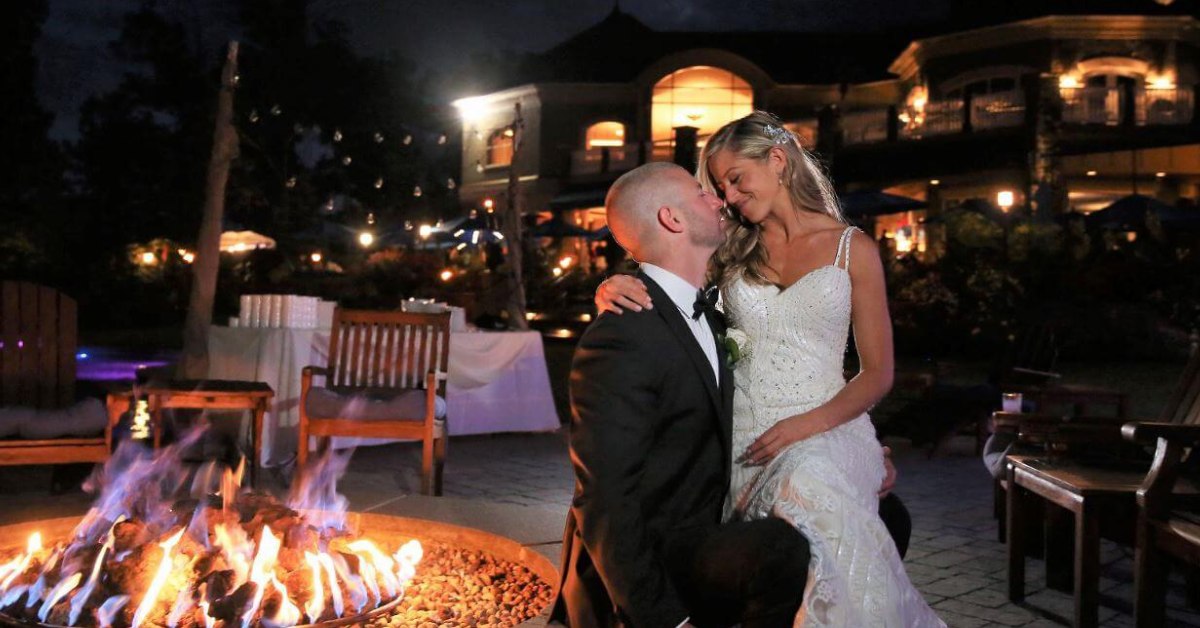 Couple sitting together next to a firepit