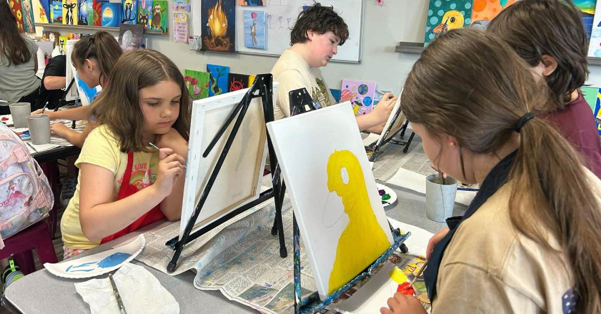 kids painting on small canvases