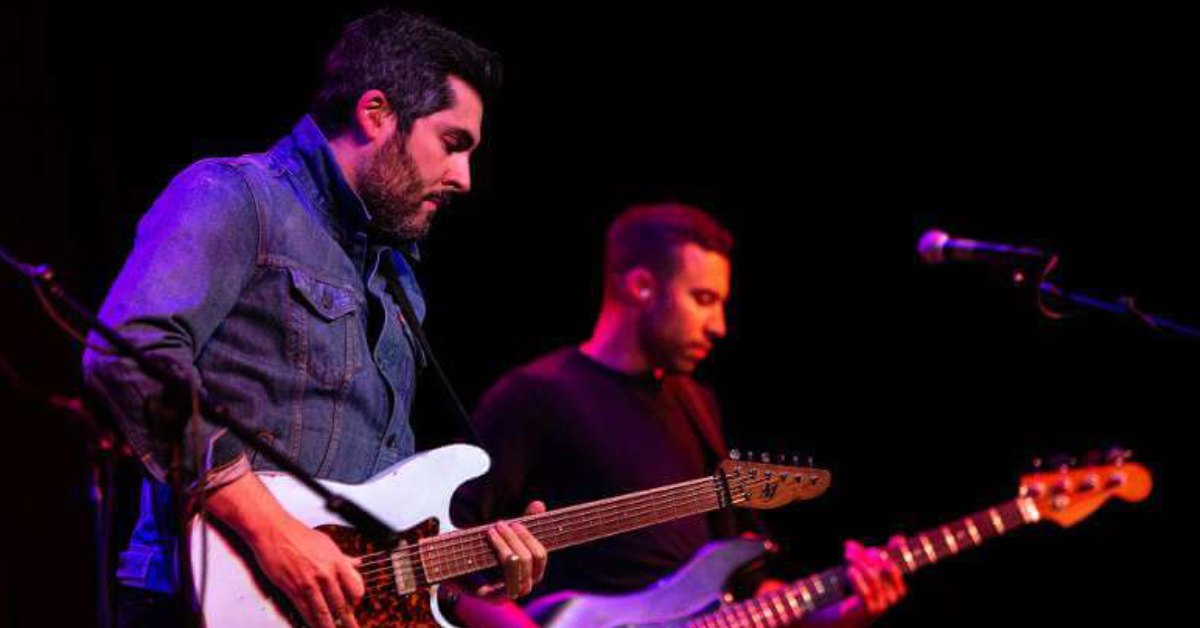 Two men playing electric guitars