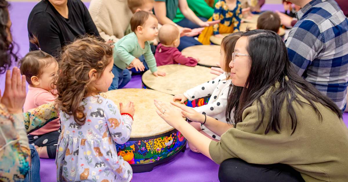 kids and adults at drums