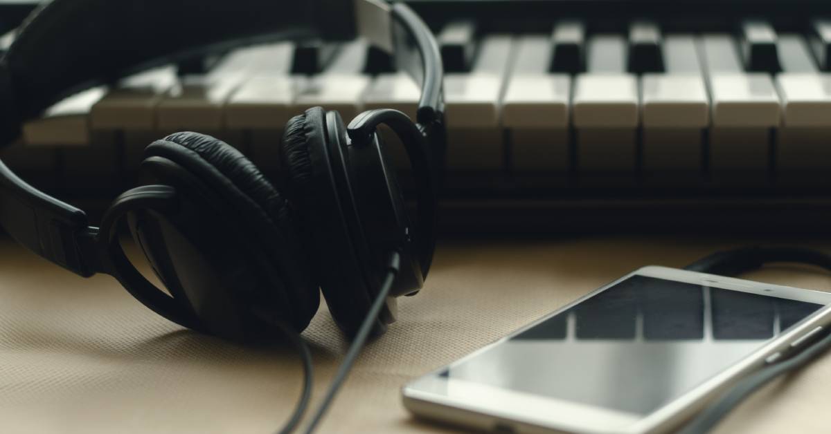 phone and headphones near keyboard