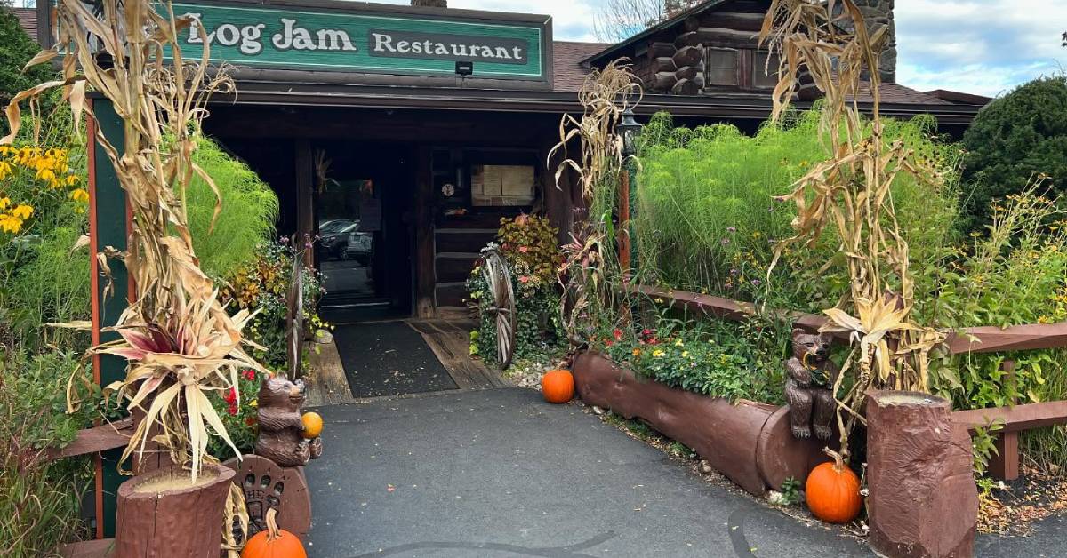 entrance to log jam restaurant decorated for fall