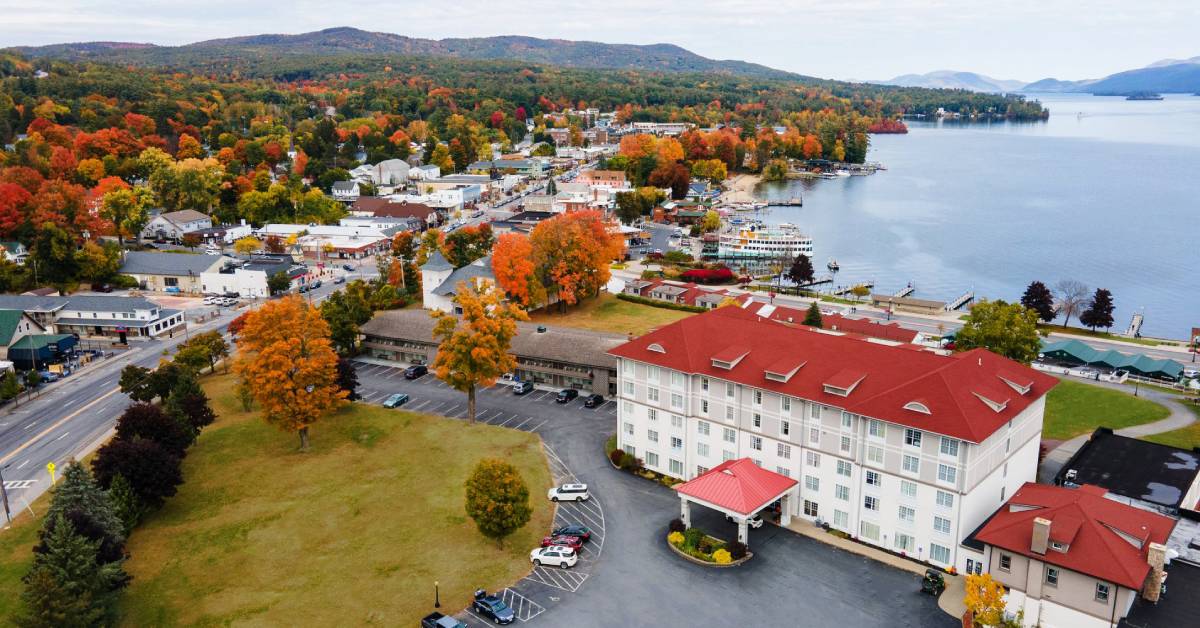 aerial view of fort william henry hotel and lake george in the fall