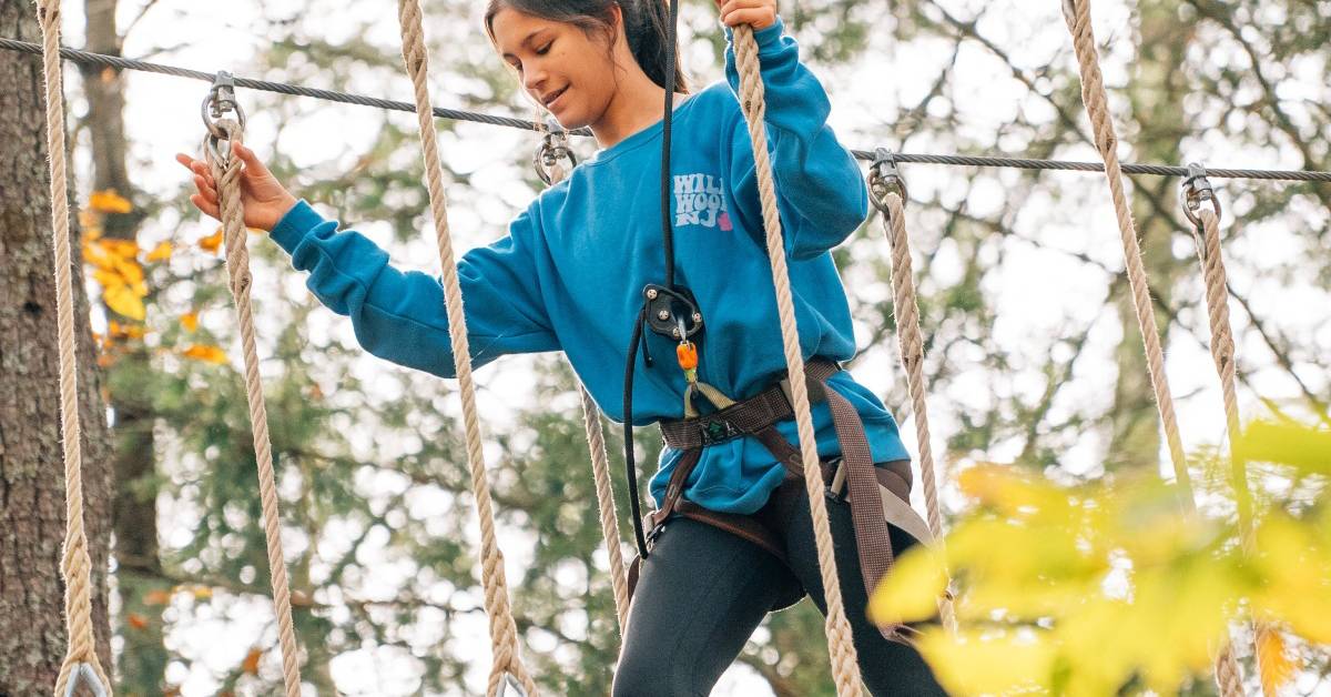 woman on treetop course in fall