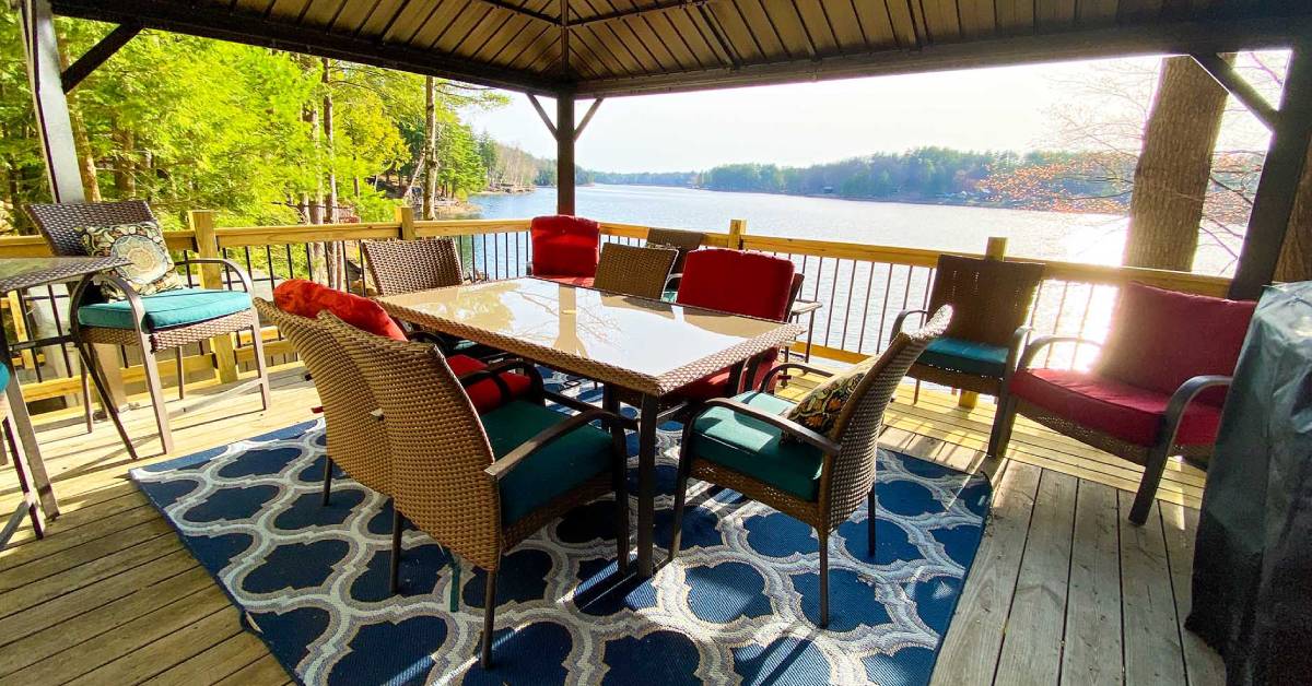 deck with dining table by lake