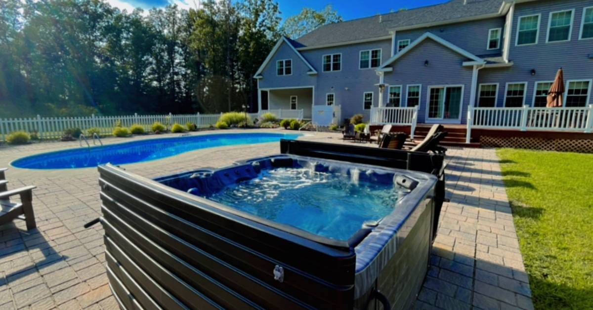 large rental house backyard with pool and hot tub