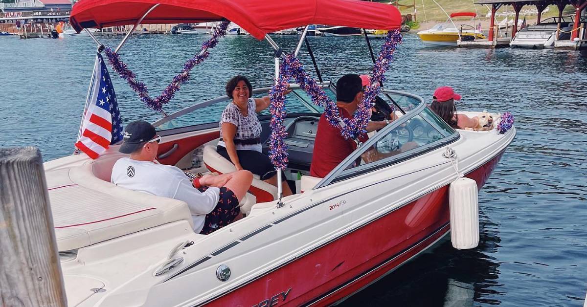 people on a boat decorated for fourth of july