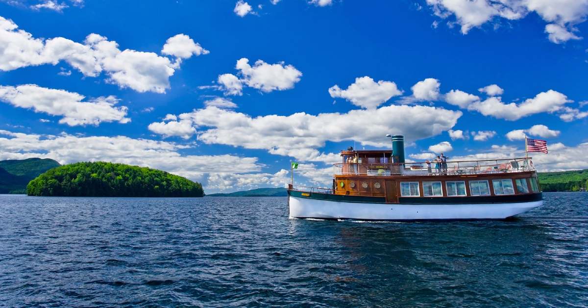 boat on a lake on a sunny day with blue sky and white clouds