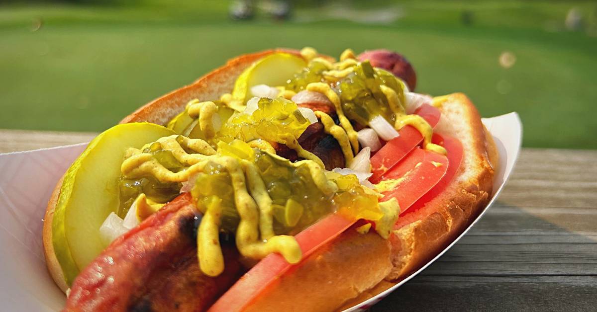 hot dog with backdrop of golf course