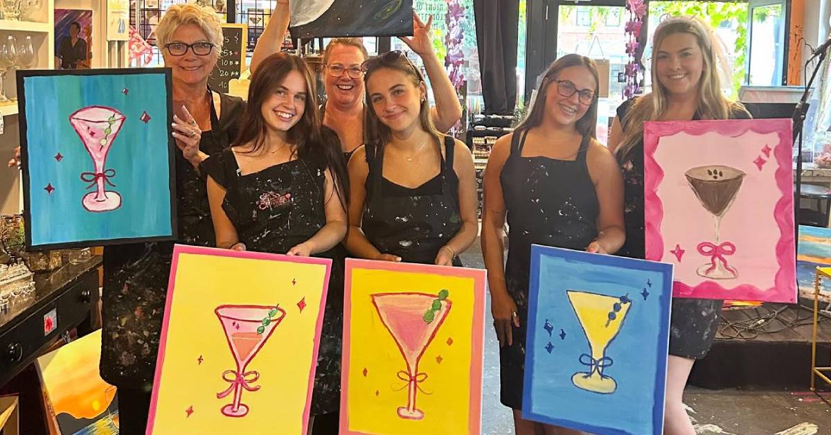 bachelorette group poses with paintings at saratoga paint and drip