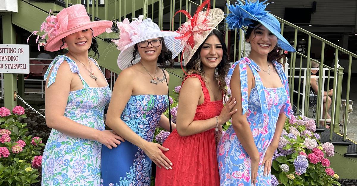 four women pose at saratoga race course
